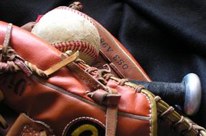 Baseball and bat in glove